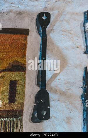 Iron tools hanging on a white wall Stock Photo