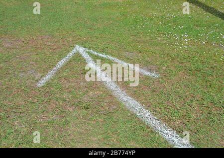 green grass or lawn with painted white arrow or pointer Stock Photo