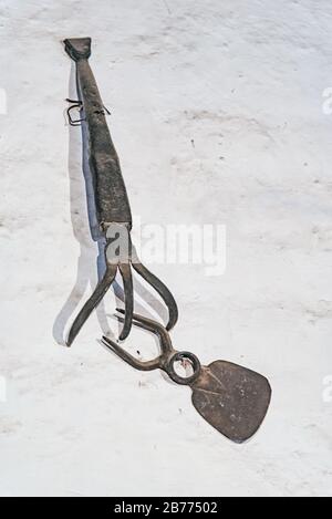 Pitchfork hanging on a white wall Stock Photo
