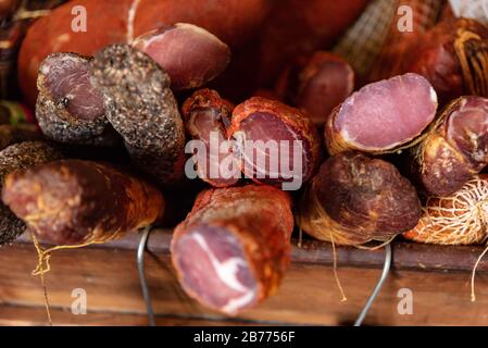 Variety of processed cold meat products. Assortment of diferent cold meats in a basket Stock Photo