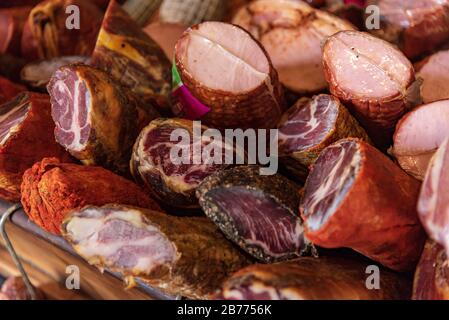 Variety of processed cold meat products. Assortment of diferent cold meats in a basket Stock Photo