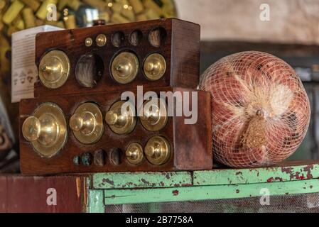 vintage set of weights in a wooden box with a cold ham in a net bag on a side Stock Photo