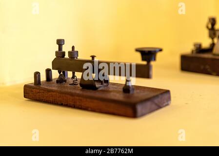 Terminal to make morse code and communicate in that way, on a yellow background Stock Photo