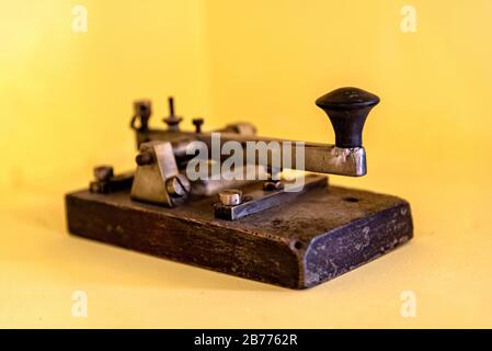 Terminal to make morse code and communicate in that way, on a yellow background Stock Photo