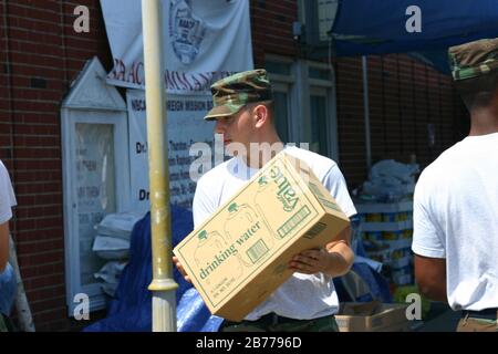 BILOXI, UNITED STATES - Sep 07, 2005: Air Force airman carries box of bottled water to church for distribution to Hurricane Katrina victims. Stock Photo