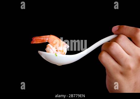 Shrimp in a spoon isolated on black background.This had clipping path. Stock Photo