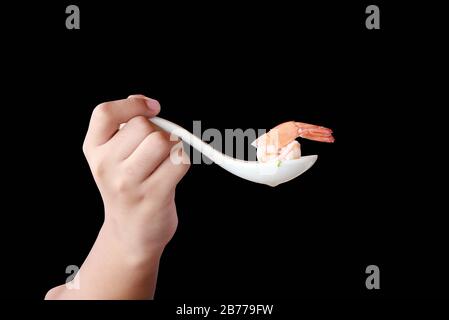 Shrimp in a spoon isolated on black background.This had clipping path. Stock Photo