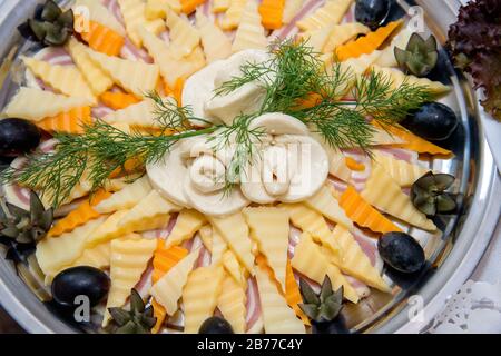 Different types delicacies of meat and cheese arranged in a plate over ...