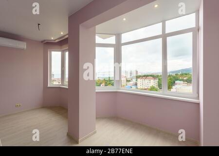 A room in a new building with a fresh renovation. The walls are pink, the floors 'under the tree'. Stock Photo