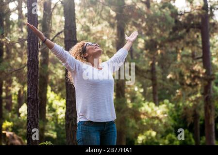 Nature lover people and woman in outdoor leisure activity - concept of environment and world forest protection - earth's day and beautiul forest wood Stock Photo