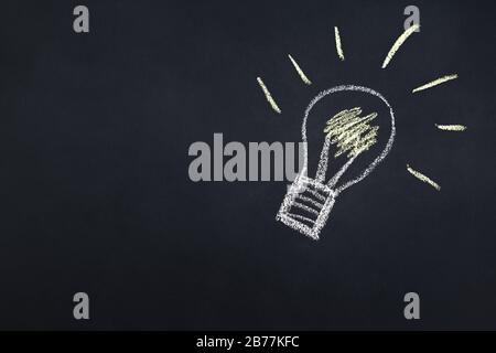 light bulb drawn with chalk on a blackboard, creativity concept for good ideas, copy space for text Stock Photo