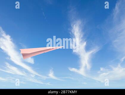 a paper plane flies in a cloudy sky Stock Photo