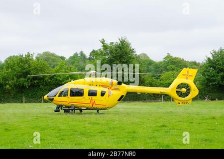 East Anglian Air Ambulance helicopter attending emergency in Much Hadham, Hertfordshire. UK Stock Photo