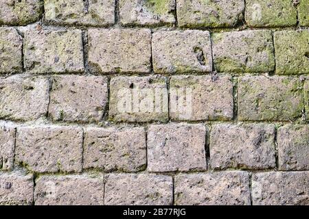 Background form a historic wall made of natural stones Stock Photo