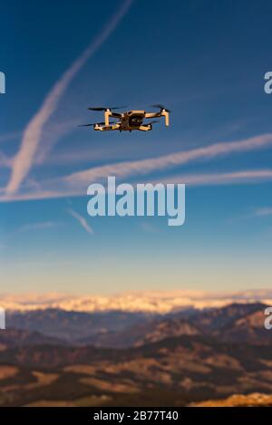 Graz, Austria - December 29 2019. DJI Mavic Mini drone flying in the countryside above Alp mountains. Drone flying. Stock Photo