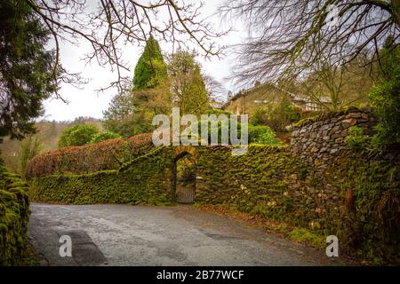 Gate in a moss covered wall, English Lake District Stock Photo