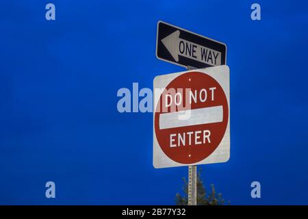 Night View of a DO NOT ENTER Sign and ONE WAY Sign Stock Photo