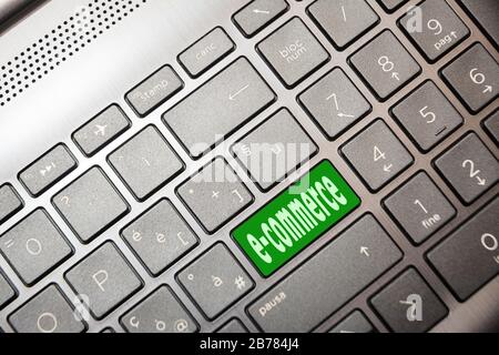Green button on the computer with the text e-commerce Stock Photo