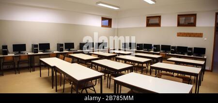 View of the interior of a classroom with row of computers on middle school. Stock Photo