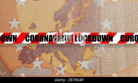Coronavirus lockdown concept: detail of a fifty euro banknote with close up of the europe map crossed by a red and white security tape with the text c Stock Photo