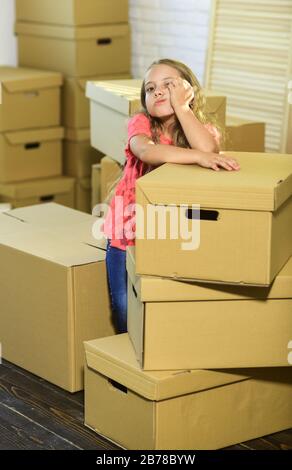 Unreal Service. purchase of new habitation. happy little girl. Moving concept. new apartment. happy child cardboard box. Cardboard boxes - moving to new house. Stock Photo