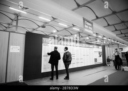 Strasbourg, France - Feb 16, 2020: Black and white image of men looking at participants at the Vignerons independant English: Independent winemakers o Stock Photo