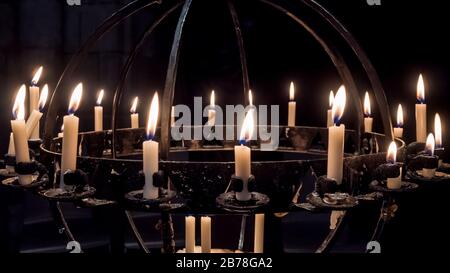 Nuremberg 2019. Candles lit in a wrought iron candle holder inside the Frauenkirche. August 2019 in Nuremberg Stock Photo