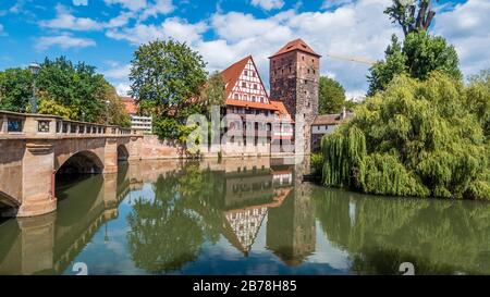 Nuremberg 2019. Weinstadel House, Hangman's Tower and the Henkersteg, or Hangman's Bridge on the Pegnitz River. We are on a hot and cloudy summer day. Stock Photo