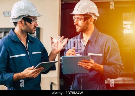 supervisor engineering team working together in heavy industry, check the machine maintenance and service. Stock Photo