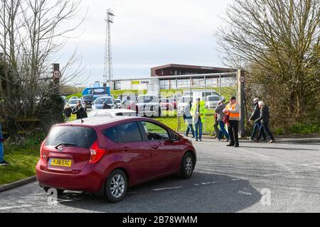 Weymouth, Dorset, UK.  14th March 2020.  Fans arriving for the Weymouth FC v Slough Town Vanarama National League South match at the Bob Lucas Stadium ahead of the 3pm kickoff.  Most National league football is still playing this weekend despite the Premier League and EFL shutting down due to the coronavirus.  Picture Credit: Graham Hunt/Alamy Live News Stock Photo