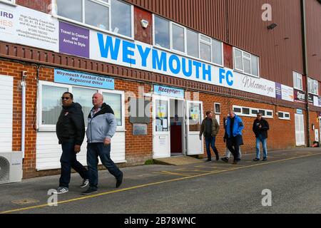 Weymouth, Dorset, UK.  14th March 2020.  Fans arriving for the Weymouth FC v Slough Town Vanarama National League South match at the Bob Lucas Stadium ahead of the 3pm kickoff.  Most National league football is still playing this weekend despite the Premier League and EFL shutting down due to the coronavirus.  Picture Credit: Graham Hunt/Alamy Live News Stock Photo