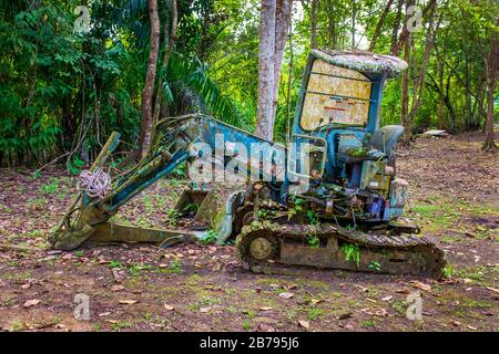 Abandoned, disused and corroding Komatsu mini excavator in the rain forest on Borneo, Malaysia Stock Photo