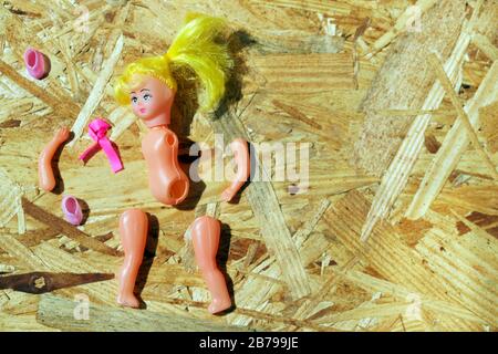 Doll body parts on a wooden background. Copy space. Top view Stock Photo