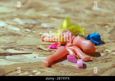 Doll body parts on a wooden background. Copy space. Top view Stock Photo