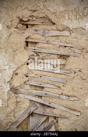 Close up of cracked adobe wall texture, clay wall from a mud house in Bulgarian Village. Stock Photo