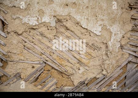 Close up of cracked adobe wall texture, clay wall from a mud house in Bulgarian Village. Stock Photo