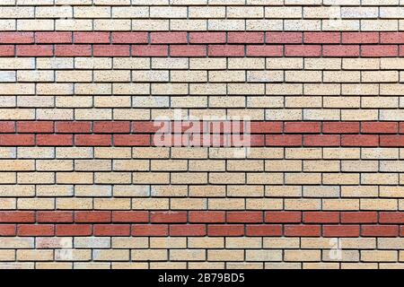 Red and beige painted brick wall background texture close up. Stock Photo