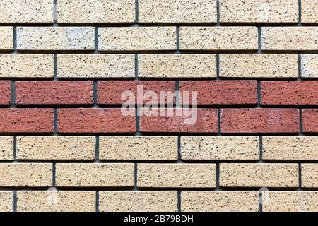 Red and beige painted brick wall background texture close up. Stock Photo