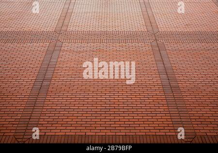 Red brick wall in perspective for background texture close-up. Stock Photo