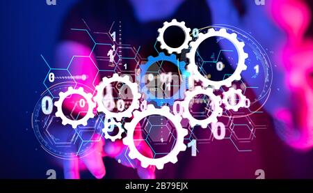 Man holding virtual gears depicting industrial technology development Stock Photo
