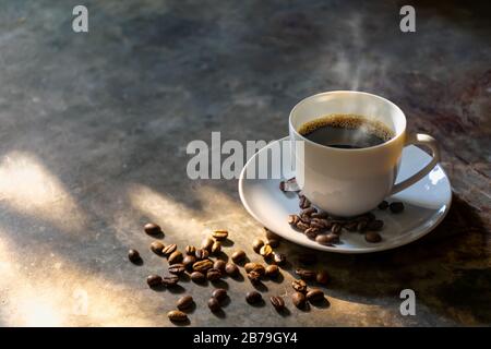 coffee cup coffee beans on the cement  background with a smoky aroma Stock Photo