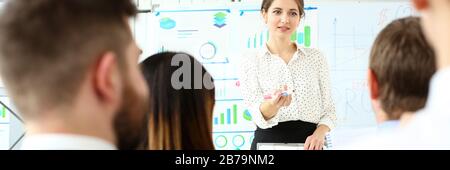 Smiling beautiful woman in office telling something important Stock Photo