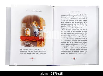 Alice Through the Looking Glass by Lewis Carroll, open at an illustration of Alice climbing through the looking glass Stock Photo