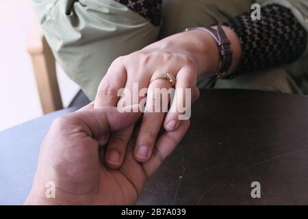 young couple holding hand each other, close up  Stock Photo