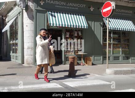 Stopping the traffic smartly dressed woman on pedestrian crossing in Sete, Southern France Stock Photo