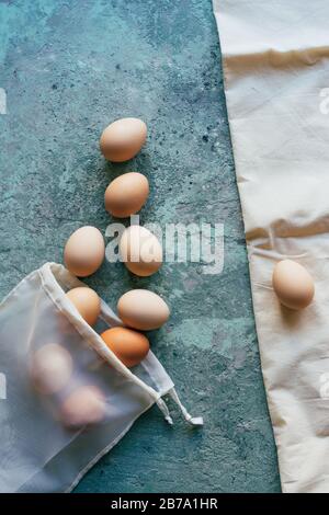 Eggs scattered from a textile white reusable shopping bag Stock Photo