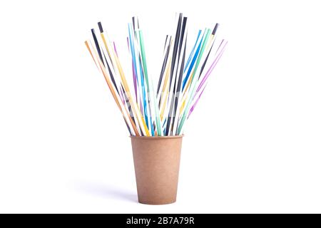 Colored paper cup with straws similar to a rainbow with many multi-colored cocktail tubes on a white background Stock Photo