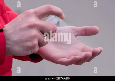 Close-up of male hand using antiseptic or anti bacteria spray. Disinfecting hands. Concept of health care during an epidemic or pandemic Stock Photo
