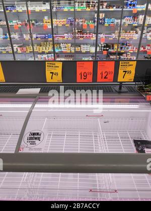 KATOWICE, POLAND - MARCH 14, 2020: Empty meat fridge in a supermarket in Poland. Local people stockpiled food in anticipation of Coronavirus (Covid-19 Stock Photo