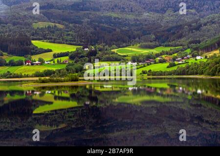Picturesque view of lake on summer gloomy rainy day ,lakeside reflection on water.Vangsvatnet lake in the municipality of Voss,Vestland county, Norway Stock Photo